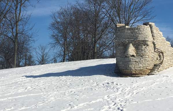 Leatherlips stone sculpture during the winter with snow on the ground.