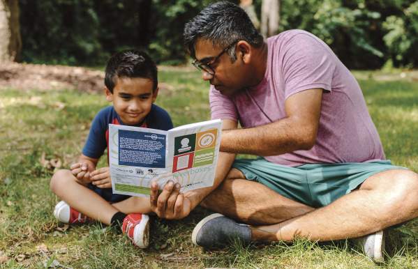 Father and son looking at the Riverboxes guide book