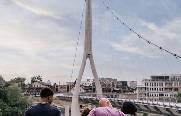 A family in Riverside Crossing Park looking out at the Dublin Link pedestrian bridge