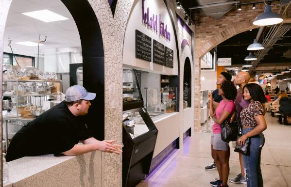 Family of four ordering from window of Falafel Kitchen at North Market Bridge Park