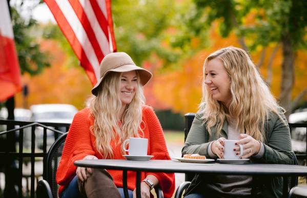 Two girls enjoying coffee on the La Chatelaine patio in Historic Dublin