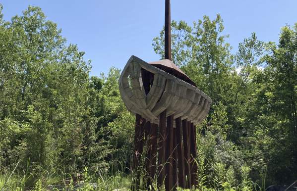 A giant wooden boat supported by beams in the air.