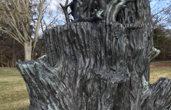 Public art installation that looks like a bronze stump of an oak tree
