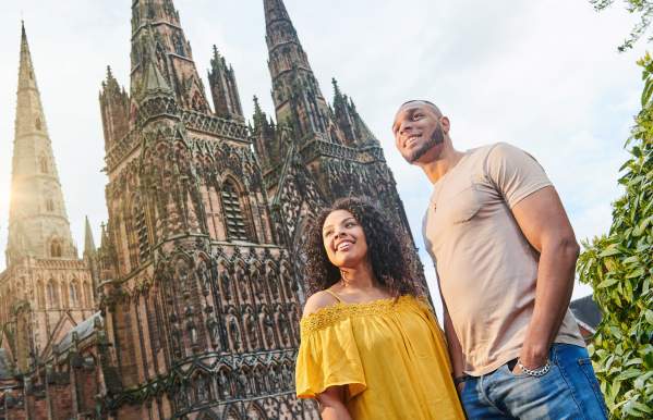 Couple outside Lichfield Cathedral on a sunny day