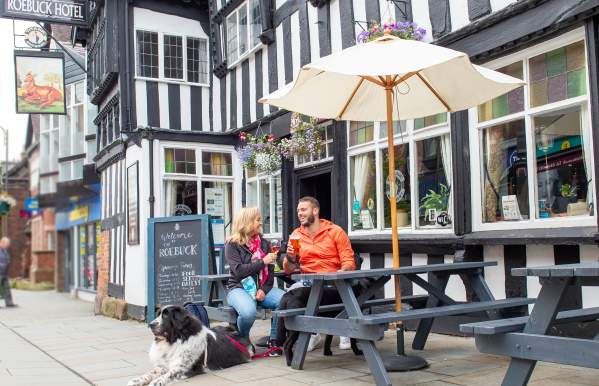 The Roebuck Leek couple drink outside with dogs