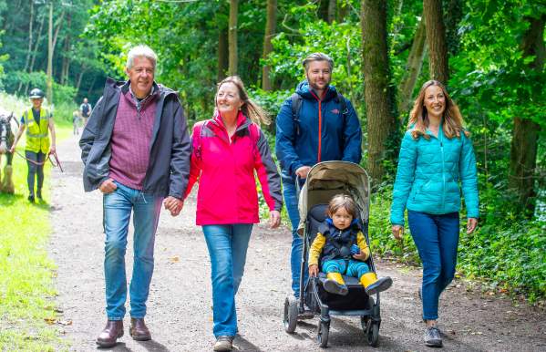 family with pushchair enjoy a country walk
