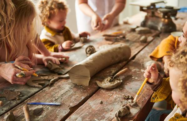young visitors play with clay