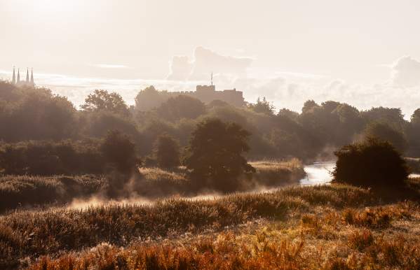 Scenic view mist rising from the river with Tamworth Castle in the distance