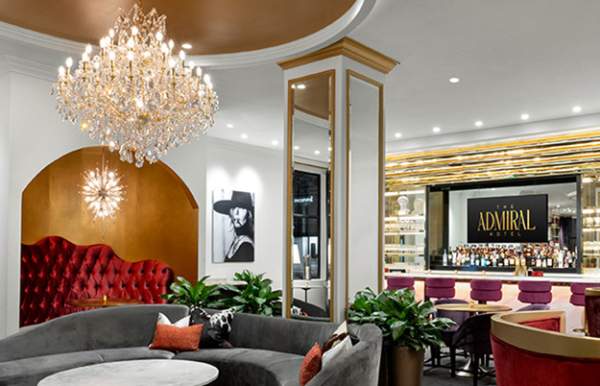 Ornate room with sectional seating and a bar