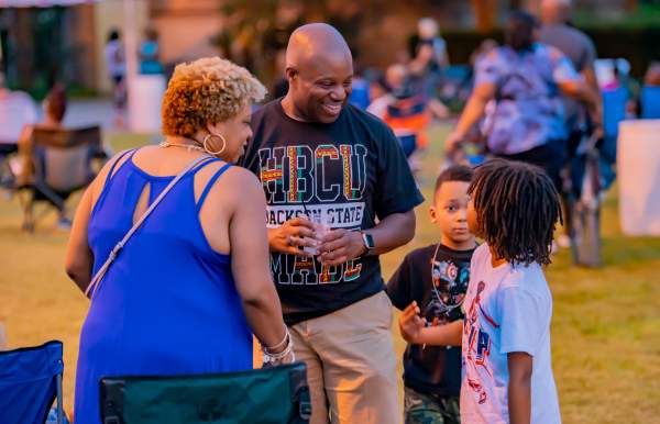 Woman, man and two small children talking