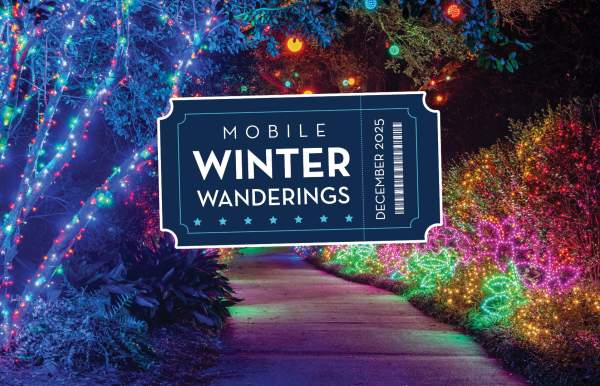 A walking path at night with trees and shrubs brightly lit with colorful lights, Mobile Winter Wanderings logo