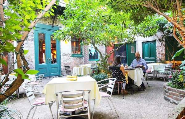 Outdoor dining on a patio with trees