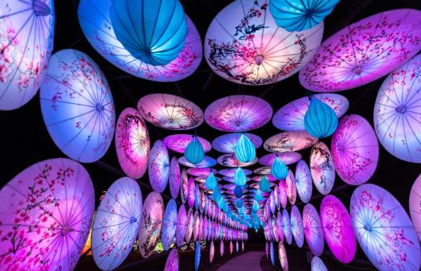 Tunnel created by hanging umbrella lanterns