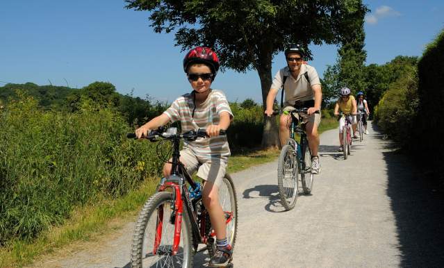 A family cycling on the Strawberry Line path near Bristol - credit Sustrans