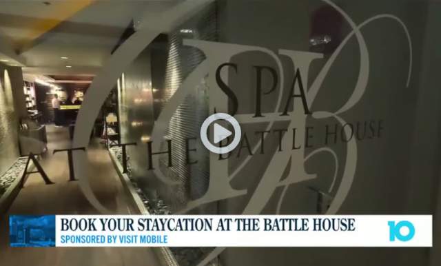 Book your staycation at the Battle House sponsored by Visit Mobile, shows the glass doors entering the Battle House Spa