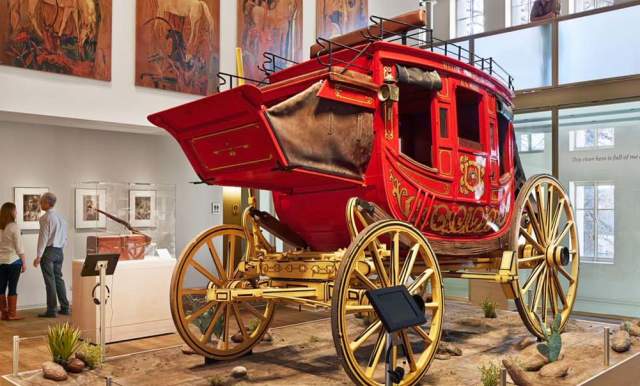 Red covered wagon inside musem exhibit