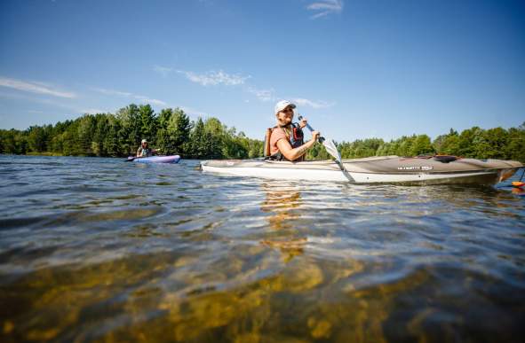 Two women kayaking along the river