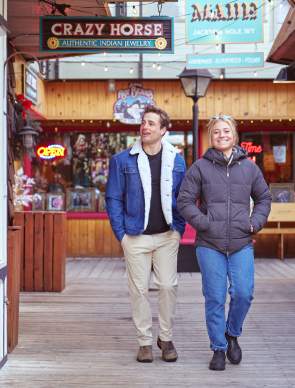 two people strolling along window shops
