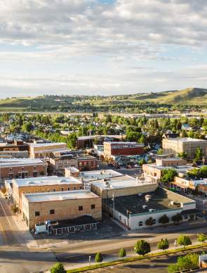An aerial overlooking view of a small town in Wyoming with streets and buildings.