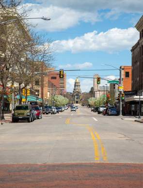 View of Capitol Avenue in downtown Cheyenne, Wyoming, featuring historic buildings and the Wyoming State Capitol.