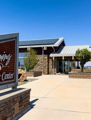 A Wyoming welcome center with a sign out front.