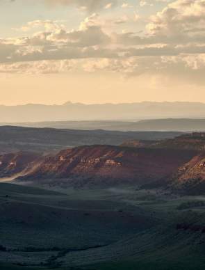 Large sweeping landscape with prairie and red dirt