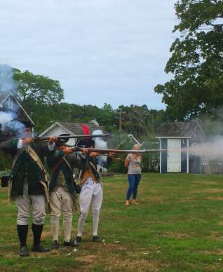 A Revolutionary War reenactment occurring at the Southold Historical Museum on Long Island.
