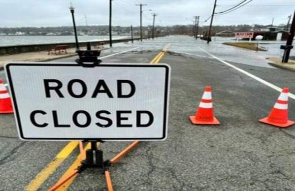 Road Closed Sign in front of flooded road