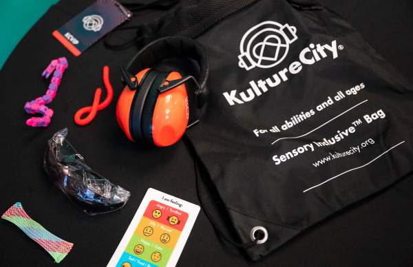Noise-cancelling headphones, communication card, fidgets, VIP lanyard, light-reducing glasses from a Sensory Inclusive® Bag from Kulture City