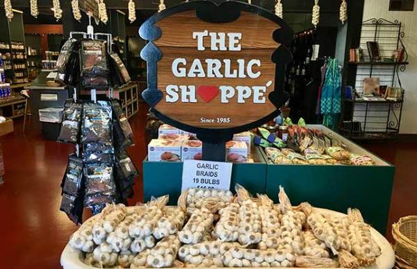 The Garlic Shoppe sign with garlic blubs near it