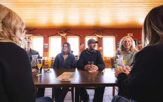 Friends smiling at the table eating dinner at Proz Lakeside in Devils Lake, ND