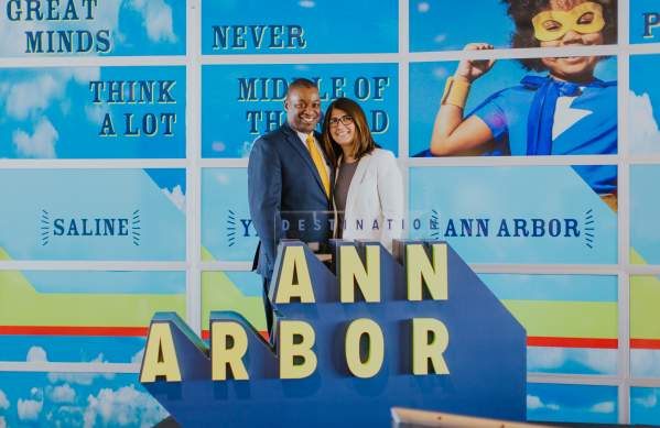 Sean Duval in front of an Ann Arbor logo sculpture
