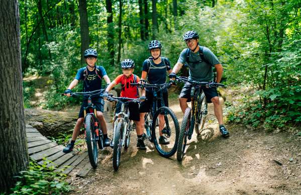 Family of four on mountain bikes on DTE Energy Foundation Trail