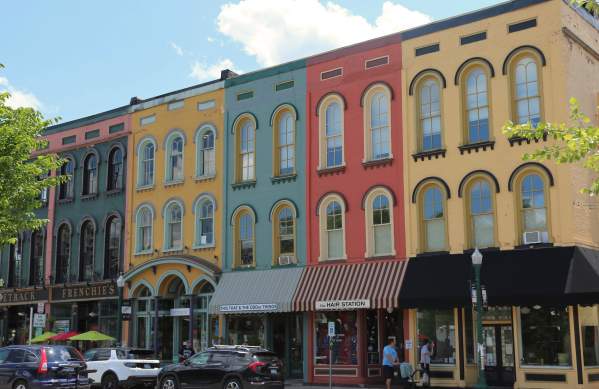 People walking by colorful buildings in Depot Town in Ypsilnati