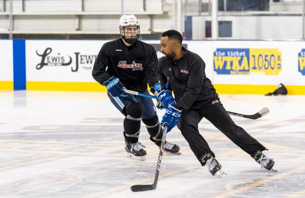 Hockey player and hockey coach on the ice