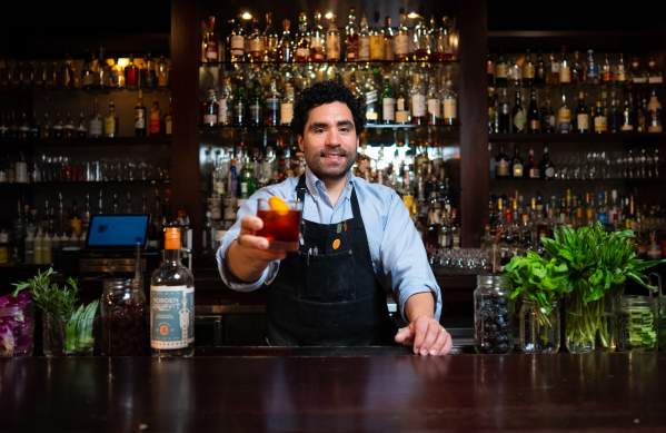 Bartender holding up a drink at The Last Word