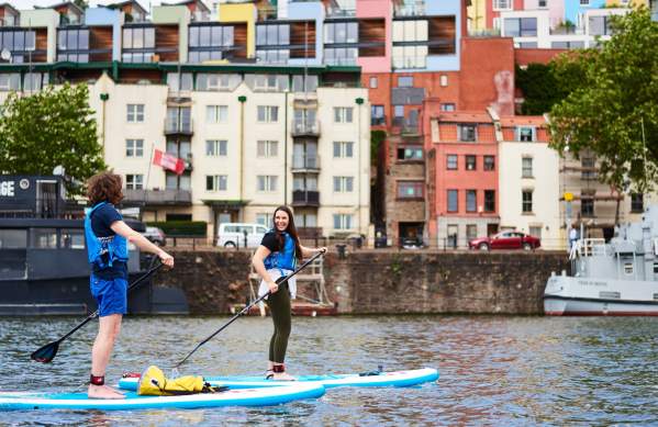 Person stand up paddleboarding in Bristol harbour - credit SUP Bristol