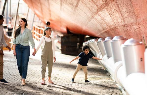 A family exploring the dry dock at Brunel's SS Great Britain, Bristol - credit Brunel's SS Great Britain