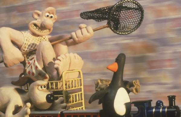 A still of the famous Claymation characters Wallace & Gromit chasing a penguin in the 1993 film The Wrong Trousers - credit Aardman Animations