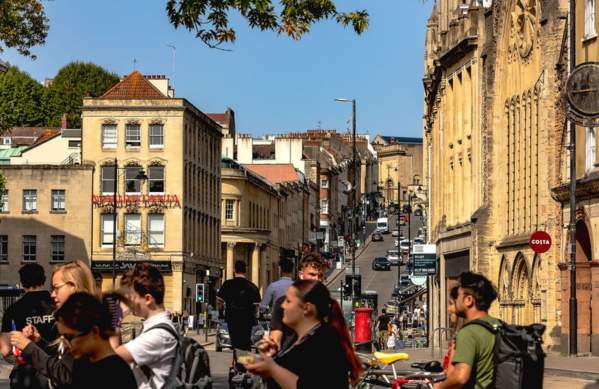A view from the bottom of Park Street in central Bristol looking uphill with people in the foreground