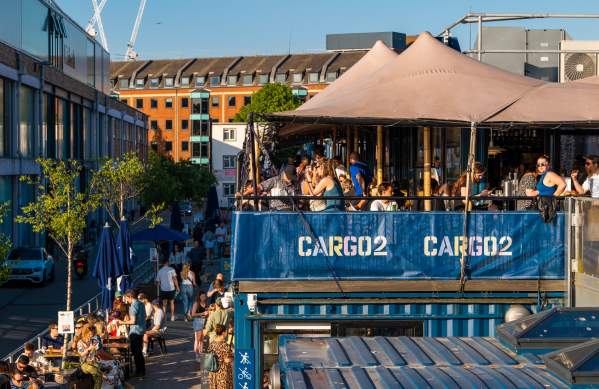 People dining alfresco at Wapping Wharf on Bristol's Harbourside - credit Hey What