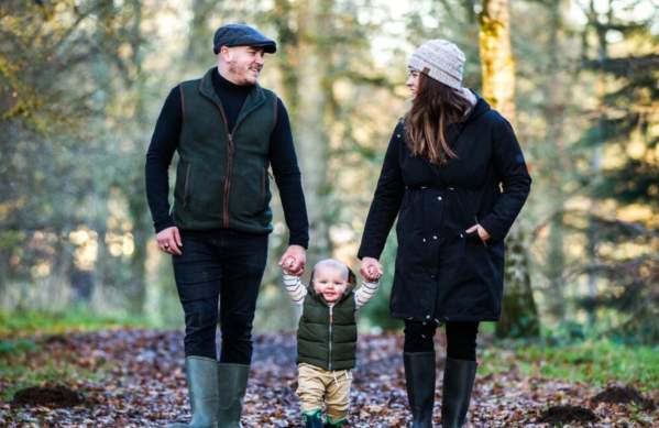 A couple walking their baby through the grounds of Westonbirt Arboretum near Bristol - credit Johnny Hathaway