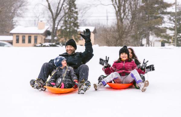 Sledding in Coffman Park Family