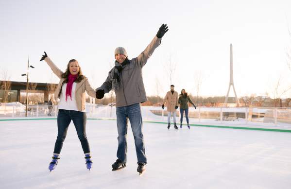 Two couples ice skating in Riverside Crossing Park