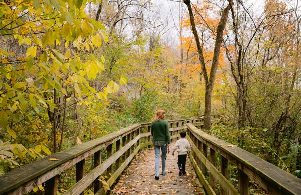 Mother and son walking the observation deck at Hayden Run Falls surrounded by fall color.