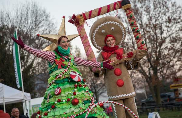 People dressed as a Christmas tree and Gingerbread man at the Tree Lighting Ceremony.