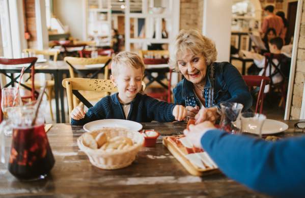 A grandma and grandchild enjoying starters in a restaurant