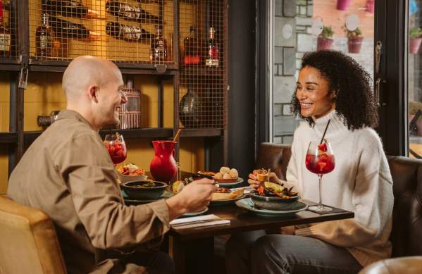 Couple enjoying evening meal and cocktails