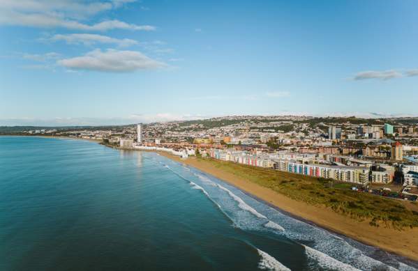 Aerial view of the swansea bay coastline with the marina and city