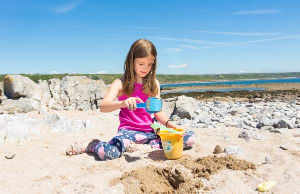 Girl building a sandcastle on the beach